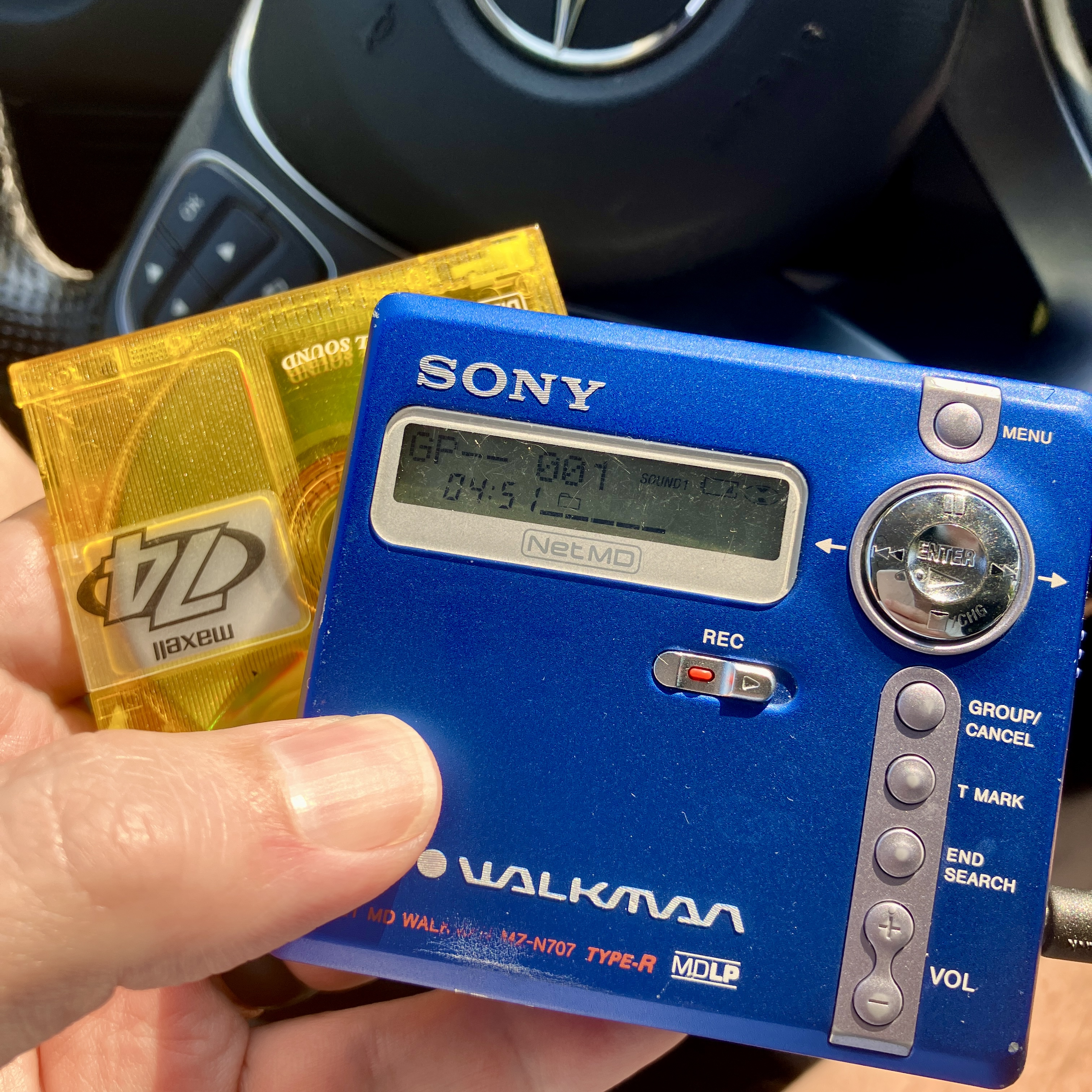 sony minidisc player in hand with disc